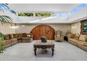 Spacious living room with vaulted ceilings and an ornate wooden door at 13626 N Tan Tara Pt, Sun City, AZ 85351