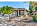 Front view of a charming single-story home with a two-car garage and a well-maintained landscape at 2064 S Farnsworth Dr # 39, Mesa, AZ 85209