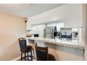 Granite countertop kitchen with breakfast bar and stainless steel appliances at 3716 E University Dr # 2014, Mesa, AZ 85205