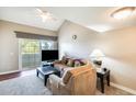 Bright living room with vaulted ceiling, comfy seating, and access to balcony at 3716 E University Dr # 2014, Mesa, AZ 85205