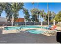 Community pool and spa area with lounge chairs and lush landscaping at 3716 E University Dr # 2014, Mesa, AZ 85205