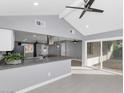 Open concept kitchen with island and view to backyard at 4345 E Desert Cactus St, Phoenix, AZ 85032