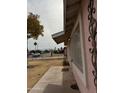 Side view of the house, showcasing the landscaping and street view at 5020 S 20Th Pl, Phoenix, AZ 85040