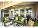Covered patio furnished with green couches and side tables at 650 N Hawes Rd # 2840, Mesa, AZ 85207