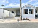 Front view of a white manufactured home with a covered porch at 954 S Nickel Dr, Apache Junction, AZ 85119