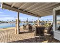 Covered waterfront patio with comfortable seating and lake views at 10601 W Bayside Rd, Sun City, AZ 85351