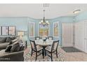 Bright dining area with table and chairs, near entryway and living room at 11500 E Cochise Dr # 1030, Scottsdale, AZ 85259