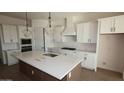 Modern kitchen featuring white cabinetry, quartz countertops, and a large island at 22783 E Stacey Rd, Queen Creek, AZ 85142