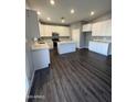 Modern kitchen with white cabinets, island, and dark flooring at 4022 S 24Th Pl, Phoenix, AZ 85040