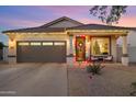 House exterior at dusk with festive lights and landscaping at 4216 E Oxford Ln, Gilbert, AZ 85295