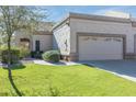 Well-maintained home with a two-car garage and landscaped lawn at 8355 W Utopia Rd, Peoria, AZ 85382