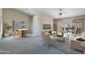 Bright living room features a staged seating area and dining space at 8355 W Utopia Rd, Peoria, AZ 85382