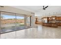 Open kitchen with island, stainless steel appliances, and backyard access at 12860 W Calle De Sol --, Peoria, AZ 85383