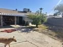 Backyard with covered patio, mature tree, and open space at 2310 N 40Th Dr, Phoenix, AZ 85009