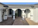 Home entrance with arched entryway and brick walkway at 5252 W Garden Dr, Glendale, AZ 85304