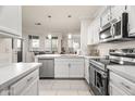 Modern kitchen with stainless steel appliances and white cabinets at 7009 E Acoma Dr # 1105, Scottsdale, AZ 85254