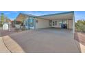 Exterior view of a home with a carport and a paved driveway at 8500 E Southern Ave # 368, Mesa, AZ 85209