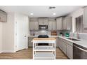 Modern kitchen with gray cabinets, quartz countertops, and stainless steel appliances at 9539 E Belmont Ave, Mesa, AZ 85208