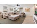 Spacious living room featuring a sectional sofa and large windows at 17040 W Echo Ln, Waddell, AZ 85355