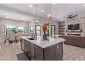 Open floor plan features a large kitchen island and flows into the dining and living areas at 21121 E Marsh Rd, Queen Creek, AZ 85142