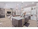 Modern kitchen with large island, stainless steel appliances, and white cabinetry at 21121 E Marsh Rd, Queen Creek, AZ 85142