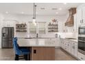 Modern kitchen with white cabinets, quartz countertops, and an island at 21354 W Minnezona Ave, Buckeye, AZ 85396