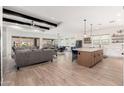 Open floor plan with hardwood floors, exposed beams, and a view of the pool at 21354 W Minnezona Ave, Buckeye, AZ 85396
