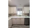 Bright kitchen featuring light cabinets, double sink, and modern appliances at 215 N Power Rd # 404, Mesa, AZ 85205
