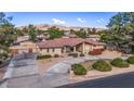 Aerial view of a single-story home with a large yard and circular driveway at 4840 W Misty Willow Ln, Glendale, AZ 85310