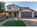 Two-story house with a brown door and attached garage, landscaped yard at 6260 S Fresno St, Chandler, AZ 85249