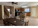 Open concept dining area with kitchen and staircase at 6705 E Flynn Ave, Florence, AZ 85132