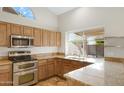 Spacious kitchen with granite countertops and stainless steel appliances at 1325 W Muirwood Dr, Phoenix, AZ 85045