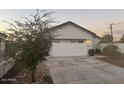 Charming house exterior, featuring a two-car garage and a tree in the front yard at 16244 N 27Th Pl, Phoenix, AZ 85032