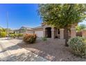 Single story house with a front yard, attached garage, and neutral color scheme at 17329 W Banff Ln, Surprise, AZ 85388