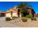 House exterior with a two-car garage and neatly landscaped yard at 17750 W Larkspur Dr, Surprise, AZ 85388