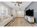 Living room features a modern TV stand and wood-look floors at 2161 E Gemini Dr, Tempe, AZ 85283