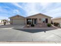 Tan house with a two-car garage and landscaped yard at 3301 S Goldfield Rd # 4094, Apache Junction, AZ 85119