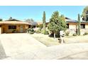 Front view of a charming home with solar panels and a well-maintained yard at 404 E Paseo De Isabella --, Casa Grande, AZ 85122