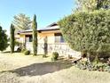 Side view of the house showcasing stone accents and lush greenery at 404 E Paseo De Isabella --, Casa Grande, AZ 85122