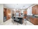 Spacious kitchen with island, stainless steel appliances, and wood cabinets at 4582 S Wildflower Pl, Chandler, AZ 85248