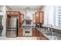 Stainless steel appliances and wood cabinetry in a well-lit kitchen at 4582 S Wildflower Pl, Chandler, AZ 85248