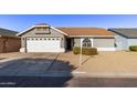 Gray house with white garage door and landscaping at 5206 N 102Nd Dr, Glendale, AZ 85307