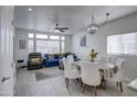 Bright dining area with white table and chairs, adjacent to living room at 7750 E Broadway Rd # 523, Mesa, AZ 85208