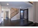 Bright entry with dark tile floors, modern staircase, and elegant front door at 933 E Driftwood Dr, Tempe, AZ 85283