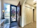 Elegant entry with decorative door and tile flooring at 10063 E Cinnabar Ave, Scottsdale, AZ 85258