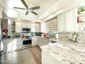 Modern kitchen featuring granite countertops and stainless steel appliances at 10063 E Cinnabar Ave, Scottsdale, AZ 85258
