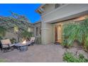 Inviting front courtyard with fire pit and seating area at 12859 W Calle De Baca Dr, Peoria, AZ 85383