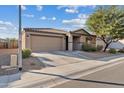 House exterior showcasing a tan-colored facade and a neatly landscaped front yard at 1805 E Grenadine Rd, Phoenix, AZ 85040