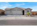 Single-story house with a three-car garage and nicely landscaped front yard at 22570 N Belt Dr, Maricopa, AZ 85138