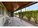 Covered porch with brick pavers and two white chairs at 3547 E Monterosa St, Phoenix, AZ 85018